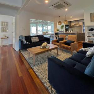 a living room with two couches and a coffee table at The Cove Cottage in Pemberton