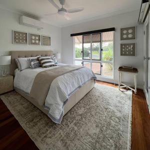 a bedroom with a large bed and a window at The Cove Cottage in Pemberton +39 photos