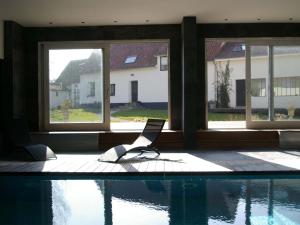 a laptop sitting next to a swimming pool at Le Clos du miroir in Courset
