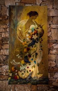 a painting of a woman with fruit on a wall at Kallisti Hotel in Potos