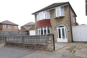 a brick house with a fence in front of it at A stylish four bedroom house in wollaton in Nottingham