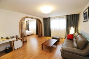 a living room with a couch and a table at Hotel the maru in Pyeongchang
