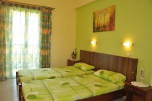 a bedroom with two beds and a window at Athina Studios in Argasi
