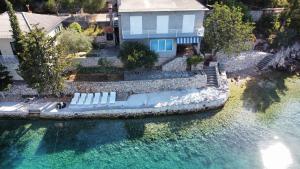 an aerial view of a house with a pool of water at Apartment Lisarica in Starigrad-Paklenica