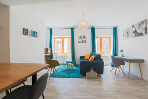 a living room with a blue couch and chairs at La Halte de Saint-Pierre in Clermont-Ferrand