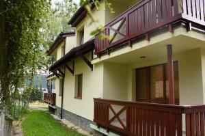 a house with red balconies on the side of it at Štýlový apartmán v srdci Donovalov in Donovaly
