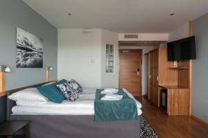 Hotelli Lähde في لابينرنتا: غرفة معيشة مع سرير وطاولة