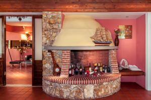 a fireplace with a model ship on top of it at Kallisti Hotel in Potos