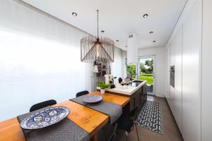 a kitchen with a dining room table and chairs at Villa Gemma - Sea Access & Private Pool in Polignano a Mare