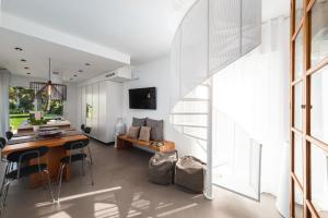 a kitchen and dining room with a table and chairs at HelloApulia Villa Gemma with private eco pool and with direct access to the sea in Polignano a Mare