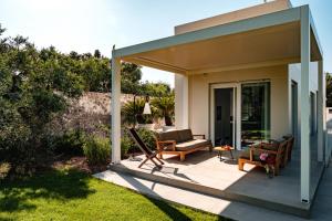 a patio with two chairs and a porch at Villa Gemma - Sea Access & Private Pool in Polignano a Mare