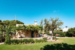 a house with a white lighthouse on top of it at Villa Gemma - Sea Access & Private Pool in Polignano a Mare