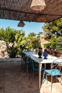 a white table and chairs on a patio at HelloApulia Villa Gemma with private eco pool and with direct access to the sea in Polignano a Mare