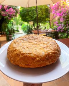 a cake sitting on a white plate on a table at El Nido de Alaro - Turismo de Interior in Alaró