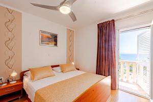 a bedroom with a bed and a large window at Apartments Separovic in Prizba +67 photos