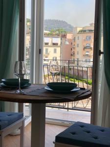 a table with two green plates on top of a balcony at B&B Historia in Pozzuoli +36 photos