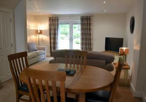 a living room with a table and a couch at Inverfinn in Killin