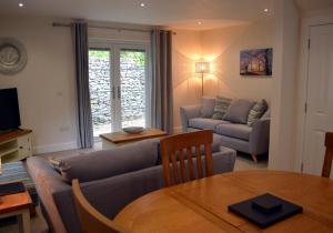 a living room with a couch and a table at Cara Anan in Killin