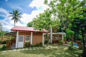 a small house with a red roof at Balay Greenika Alfonso Nature Resort in Alfonso