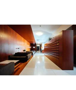 a lobby with couches and tables in a building at T0 no centro do Porto in Porto