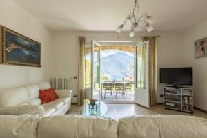 a living room with a couch and a table at Apartment Maya - Tremezzina in Tremezzo