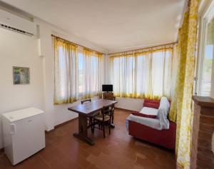 a living room with a table and a couch at Azienda Agricola Sapereta in Porto Azzurro