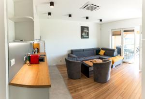 a living room with a couch and a table at Żwirek Muchomorek in Sterławki Małe +20 photos
