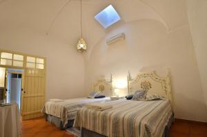 a bedroom with a large bed and a large window at Casa de Serpa - Turismo Rural in Serpa