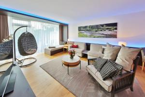 a living room with a couch and a table at Mawell Resort in Langenburg