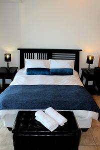 ein Schlafzimmer mit einem großen Bett mit zwei Kissen in der Unterkunft Hibernian Towers in Kapstadt