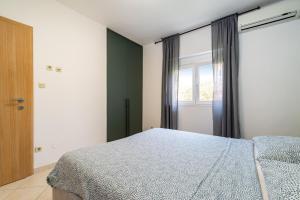 Postel nebo postele na pokoji v ubytování Villa Helena Rovanjska