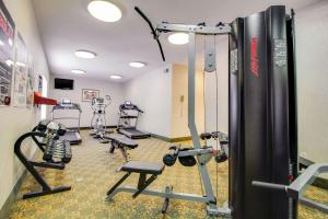 a gym with treadmills and machines in a room at MainStay Suites Texas Medical Center-Reliant Park in Houston