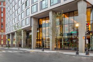 a large building with glass windows on a city street at Cambria Hotels Boston Downtown - Seaport in Boston