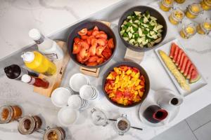 a table with three bowls of vegetables and drinks at Park Inn by Radisson Vilnius Airport Hotel & Conference Centre in Vilnius