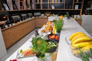 a long table with many plates of food on it at Park Inn by Radisson Vilnius Airport Hotel & Conference Centre in Vilnius