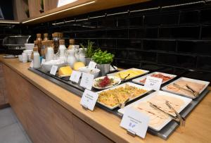 a buffet line with many different types of food at Park Inn by Radisson Vilnius Airport Hotel & Conference Centre in Vilnius