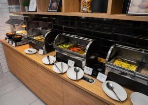 a buffet line with many different types of food at Park Inn by Radisson Vilnius Airport Hotel & Conference Centre in Vilnius