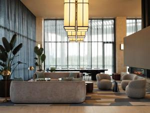 a living room with a couch and a piano at Hyatt Place Melbourne Caribbean Park in Scoresby