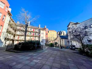 una calle de la ciudad con edificios y una torre del reloj en Stunning 2 Bed Apt Nr The Royal Mile & The Castle, en Edimburgo