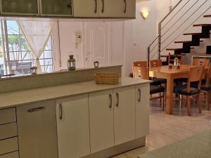 a kitchen with a counter and a dining room at Riumar "La Pinya", 500m to beach, Privat-Pool, On-Site-Service, dog beach in Riumar