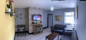 a living room with a couch and a tv at Nuns Moor fully equipped kitchen free parking Netflix in Newcastle upon Tyne