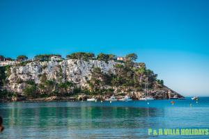 a view of a small island in the water at Villa Can Pere Cala Galdana Menorca in Cala Galdana