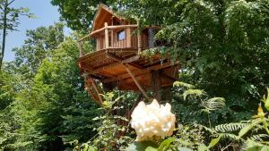 a tree house with a flower in front of it at Caban'Aspe in Accous