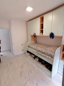 um quarto com uma cama e armários brancos em Casa SoSò em Massa