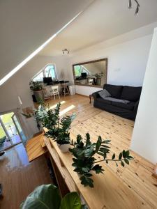 a living room with a table with plants on it at APARTAMENT LOFT z ANTRESOLĄ w GDAŃSKU in Gdańsk