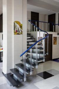 a spiral staircase with blue railings in a house at Good Hotel Yerevan in Yerevan