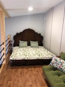 a bedroom with a large bed with a wooden headboard at Karlsons Antique in Liepāja