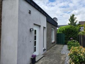 a white building with a door on the side of it at Das Wassertürmchen in Nettetal