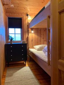 a bedroom with a bunk bed and a window at Kultan in Åmotsdal