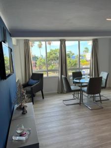 a living room with a table and chairs at CORNELIAS HOME TC1 vista marina in Los Cristianos